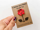 a person holding a card with a flower on it