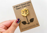 a hand holding a card with a flower on it