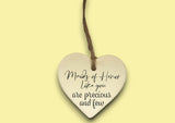 a heart shaped ceramic ornament with a message