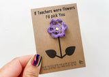 a person holding a card with a flower on it