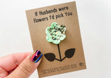 a hand holding a card with a flower on it