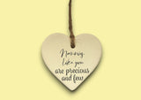 a ceramic heart hanging on a string