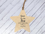 a wooden star ornament hanging from a string