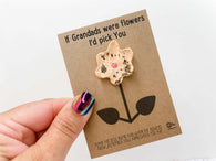 a hand holding a card with a flower on it