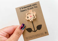 a hand holding a card with a flower on it