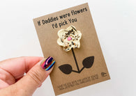 a hand holding a card with a flower on it