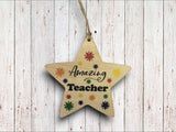 a wooden star ornament hanging on a wall