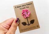 a hand holding a card with a flower on it