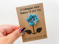 a person holding a card with a flower on it