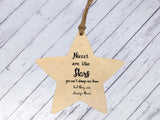 a wooden star ornament with a message on it