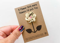 a hand holding a card with a flower on it